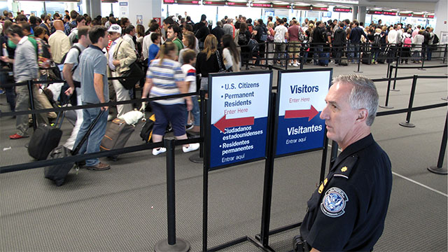 Newly landed passengers wait to be processed through U.S. immigration at JFK airport in New York.