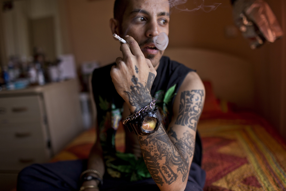 Tattoo artist Siavash smokes a cigarette. Tattoos have been part of Iranian culture since ancient times, but today they are often seen as copies of Western culture. “Cultural and political influences are more dangerous than economic and security ones,” said Supreme Leader Ali Khamenei. ICHRI photo by Hossein Fatemi.