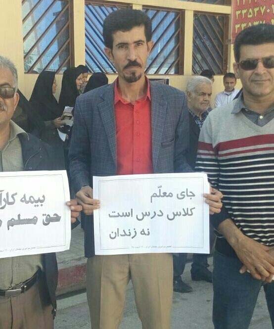 Teachers' rights activist Taher Ghaderzadeh's sign reads: "A teacher's place is in a classroom, not a prison."